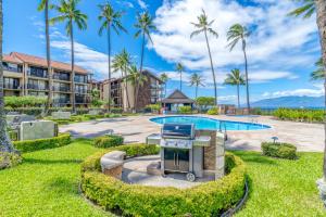 a resort with a pool and palm trees at Papakea A203 in Lahaina