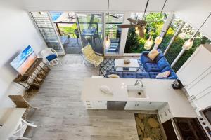 a living room with a blue couch and a table at Hale Kai 220 in Kahana