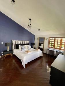 a bedroom with a white bed and a blue wall at Beautiful Jungle House on a strategic location in Cancún