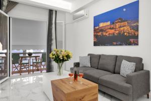 a living room with a couch and a table at Athenian Destiny Suite in Athens