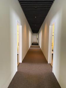a hallway with white walls and a black ceiling at Fljótsbakki Hotel in Godafoss