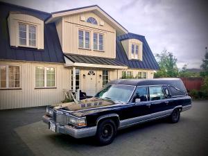 a black car parked in front of a house at The White House in Reykholt