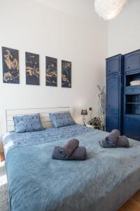 a bedroom with a large bed with towels on it at Magnolia apartment in Zagreb