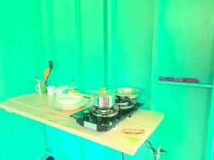 a counter with two pots and pans on a stove at Simple Rustic studio deluxe bed in tropical fruits garden in Mountain View