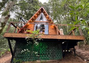 une cabane dans les arbres avec une fenêtre dans la forêt dans l'établissement Chalé da Roça - Garibaldi, à Garibaldi