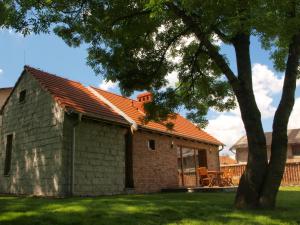 a small brick house with an orange roof at Lake House in Kościan
