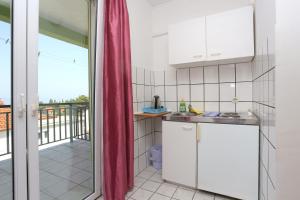a kitchen with a view of a balcony at Studio Gradac 2784d in Gradac