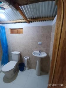 a bathroom with a toilet and a sink at Finca El Encanto del Guejar in Lejanías +65 photos