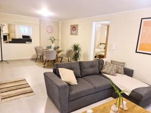 a living room with a couch and a table at Filoxenia Luxury Home Patras in Patra
