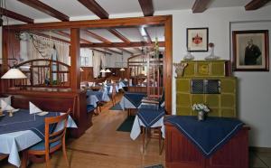 a dining room with blue tables and chairs at Gasthof Landhotel Hirsch in Ostrach