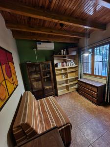 uma sala de estar com um banco e uma estante de livros em Casa Moldes, Alto Dorrego - Mendoza em Guaymallén