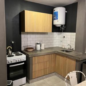 a kitchen with a sink and a stove top oven at Moderno departamento frente a ciudad cultural II in San Salvador de Jujuy