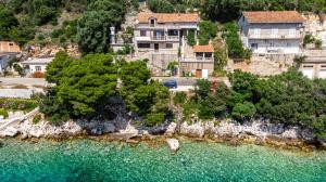 an aerial view of a large house on a hill next to the water at Apartments by the sea Ubli, Lastovo - 16599 in Lastovo