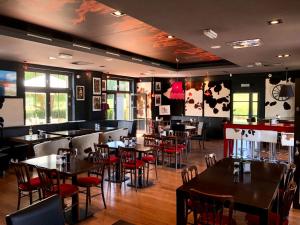 a dining room with tables and chairs in a restaurant at Apartamenty Klifowa 7 in Niechorze