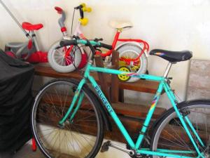 a blue bike parked next to two red bikes at Gîte Champêtre avec Piscine Chauffée, Cheminée, et Terrasse en Plein Sud - FR-1-410-131 in La Chapelle-aux-Choux