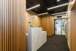 un hall de bureau avec des panneaux en bois et un comptoir de réception dans l'établissement Quay Perth, à Perth