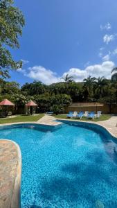 a large swimming pool with blue water at Posada Pittier 