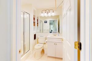 a white bathroom with a toilet and a sink at Town of South Bethany --- 142 Henlopen Drive in Bethany Beach +29 photos