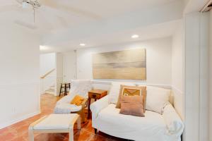 a living room with a white couch and a table at Town of South Bethany --- 142 Henlopen Drive in Bethany Beach
