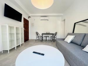a living room with a couch and a table at GOLDEN COAST CALAFELL 2 in El Vendrell