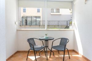 una mesa pequeña y 2 sillas en una habitación con ventana en Apartments with a parking space Kastel Stafilic, Kastela - 20926, en Kaštela