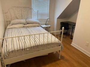 a white bed in a room with a staircase at Quad Room with En Suite Bathroom 536A in Toronto