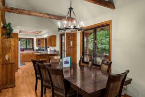 a kitchen and dining room with a wooden table and chairs at Sky Serenity in Skykomish
