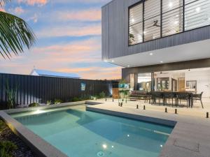 a swimming pool in the backyard of a house at Breeze at Salt - Wheelchair Accessible with Heated Pool in Kingscliff