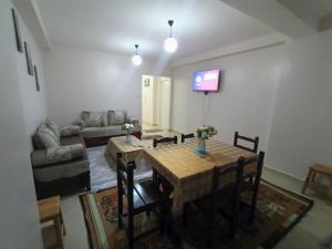 a living room with a table and a couch at BEJAIA Location Appartement ou Voiture in Bejaïa