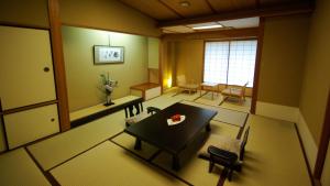 a dining room with a table and chairs in a room at Kasuga Hotel in Nara