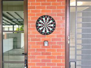 a dart board on the side of a brick wall at RAPID Pelali Pengerang Homestay in Pengerang