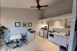 a kitchen with a table and chairs and a ceiling fan at V&S Hostel Boutique in Buenos Aires