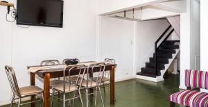 a dining room with a table and chairs and a staircase at Balcones de Salta in Salta