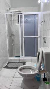 een badkamer met een douche en een toilet. bij Sirius Apart in Puerto Iguazú