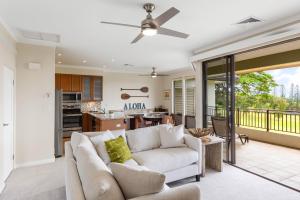a living room with a couch and a kitchen at Kapalua Golf Villa 18V4 in Kahana