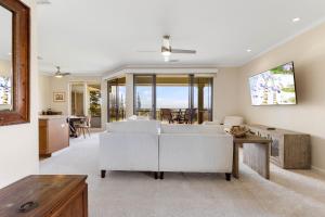 a living room with a white couch and a table at Kapalua Golf Villa 18V4 in Kahana