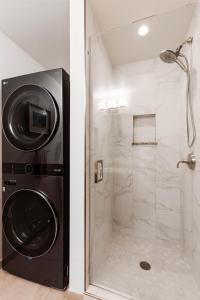 a bathroom with a shower and a washing machine at Kapalua Golf Villa 18V4 in Kahana +7 photos