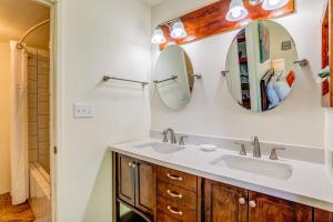 a bathroom with a sink and a mirror at Paki Maui 327 in Kahana +19 photos