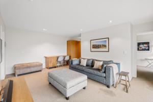 a living room with a couch and a table at Cedar House by Sotheby's Luxury Rental Homes in Wanaka