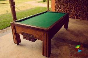 a pool table with a green cloth on it at Hotel Fazenda Coninho in Inhaúma