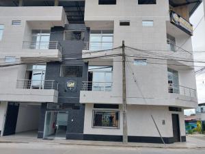 a building with a sign on the side of it at Hospedaje Moralillos in Yurimaguas