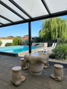 a patio with a table and chairs and a pool at Appartement 2 in Bersenbrück