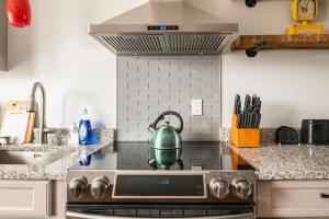 a kitchen with a stove with a tea kettle on it at Historic Hagerstown Antietam Battlefield WhiteTail in Hagerstown