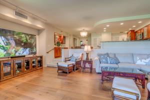 a living room with a couch and a tv at Kaanapali Royal D101 in Lahaina