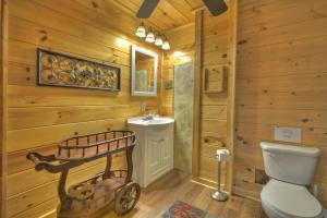 a bathroom with a white toilet and a sink at Bella Vista in Ellijay +34 photos