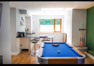 a kitchen with a pool table in a room at House of Kaima - 6 bed detached in Dewsbury