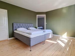 een bed in een kamer met een groene muur bij Holiday home Moheda II in Moheda