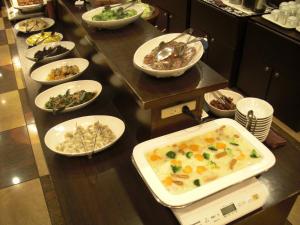 una linea a buffet con ciotole di cibo su un tavolo di Kuretake-Inn Fujisan a Fuji