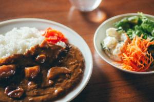 a table with two plates of food and a bowl of rice at Hamamatsu Station Hotel in Hamamatsu