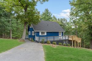 a blue house with a porch and a deck at New! Sapphire Ridge Escape to Shenandoah River in Front Royal